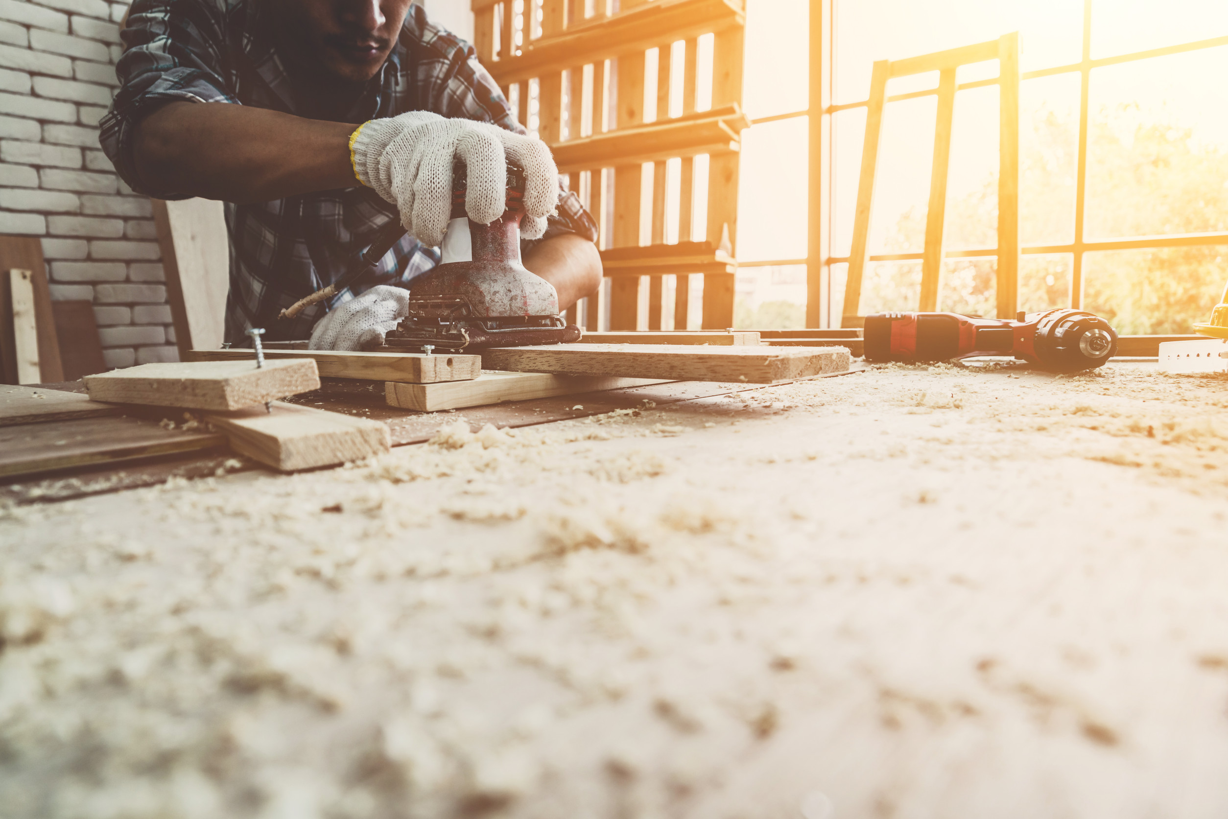 Carpenter working on wood craft at workshop